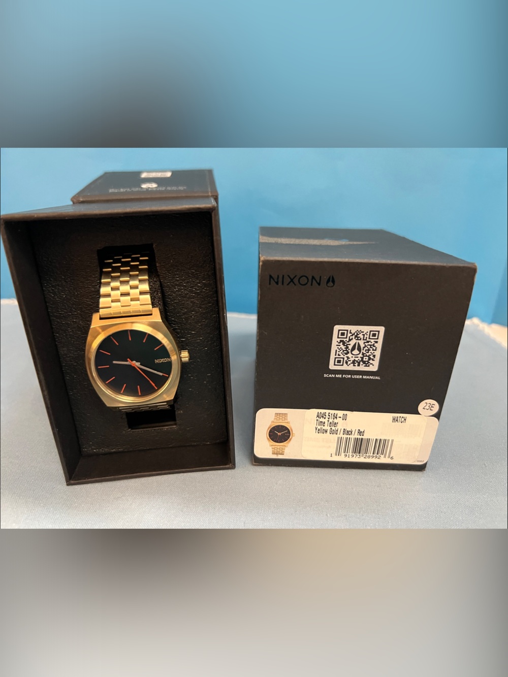 Nixon Gold Watch with Black Dial and Red Accents, Time Teller Model